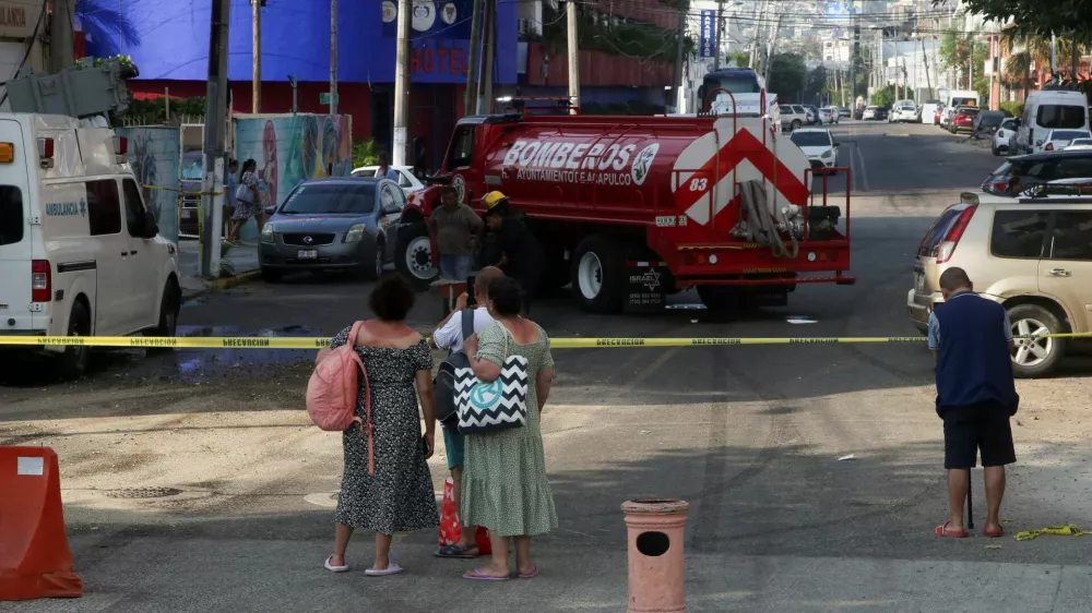 People watch as firefighters work in the area where a transformer fell on an ambulance following an earthquake in Acapulco, Mexico, January 2, 2026. REUTERS/Javier Verdin