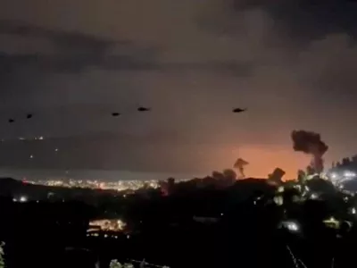 Helicopters fly past plumes of smoke rising from explosions, in Caracas, Venezuela, January 3, 2026 in this screen grab obtained from video obtained by Reuters. Video Obtained by Reuters/via REUTERS THIS IMAGE HAS BEEN SUPPLIED BY A THIRD PARTY. NO RESALES. NO ARCHIVES. NEWS USE ONLY. THIS PICTURE WAS PROCESSED BY REUTERS TO ENHANCE QUALITY. AN UNPROCESSED VERSION HAS BEEN PROVIDED SEPARATELY. VERIFICATION: - Mountains, towers and buildings match satellite and file imagery of Caracas - Date verified by multiple corroborating videos of strikes on Caracas   TPX IMAGES OF THE DAY
