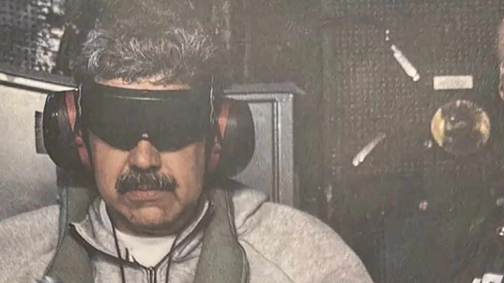 A photograph which U.S. President Donald Trump posted on his Truth Social account shows what he describes as Venezuelan President "Nicolas Maduro on board the USS Iwo Jima" amphibious assault ship, currently in the Caribbean Sea January 3, 2026. The image appears to be taken from a printed photograph, as white edging can be seen around the image. What appears to be the letters DEA can be seen on a black uniformed person next to Venezuelan president Maduro. U.S. president Trump said DEA officials were involved in the operation. Verifying the location was not immediately possible as the photograph is tightly cropped. But the patterning of grey hairs within Maduro's mustache matched recent imagery of him. @realDonaldTrump/Handout via REUTERS THIS IMAGE HAS BEEN SUPPLIED BY A THIRD PARTY. THIS PICTURE WAS PROCESSED BY REUTERS TO ENHANCE QUALITY. AN UNPROCESSED VERSION HAS BEEN PROVIDED SEPARATELY.