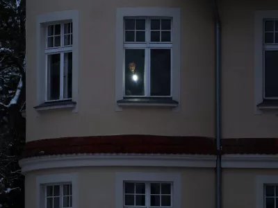 A man uses a torch in his apartment during a blackout that left thousands of homes without electricity after a suspected arson attack at the power plant Lichterfelde, in the district Steglitz-Zehlendorf, in southern Berlin, Germany, January 4, 2026. REUTERS/Lisi Niesner