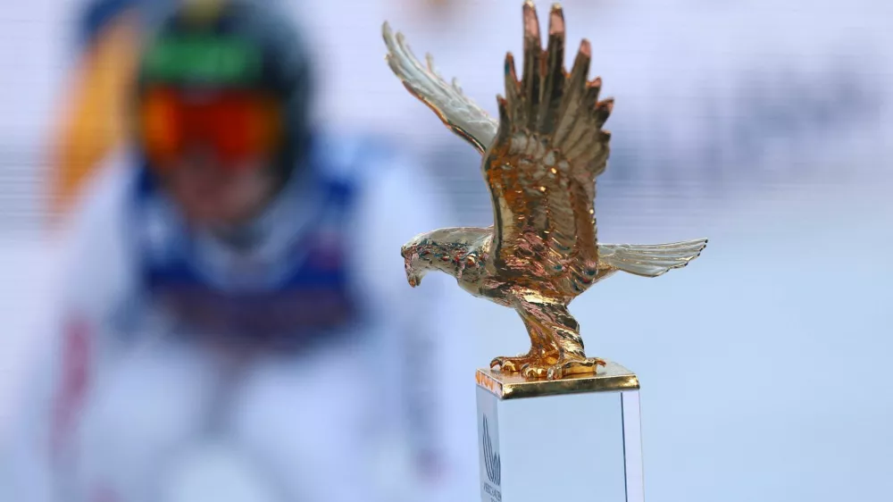 Ski Jumping - Four Hills Tournament - Innsbruck, Austria - January 4, 2026 General view of the trophy on display as Switzerland's Sandro Hauswirth in action during his jump REUTERS/Kai Pfaffenbach