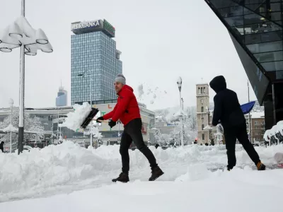 People clear snow from a street in Sarajevo, Bosnia and Herzegovina, January 5, 2026. REUTERS/Amel Emric