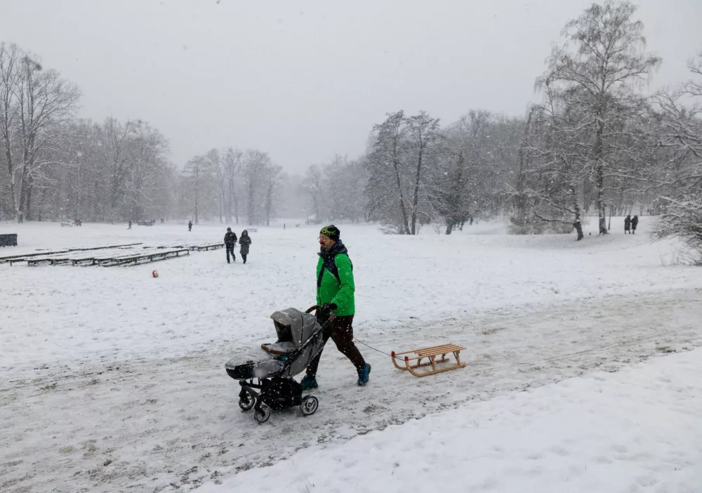 A man walks with a sledge and a baby stroller in a snow-covered Maksimir park in Zagreb, Croatia, January 6, 2026. REUTERS/Antonio Bronic