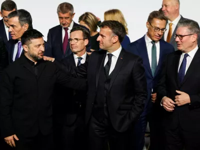 Ukraine's President Volodymyr Zelenskiy, France's President Emmanuel Macron and Britain's Prime Minister Keir Starmer react as they stand for a family photo, on the sideline of the so-called 'Coalition of the Willing' summit, at the Elysee Palace in Paris, France, January 6, 2026. Ludovic Marin/Pool via REUTERS