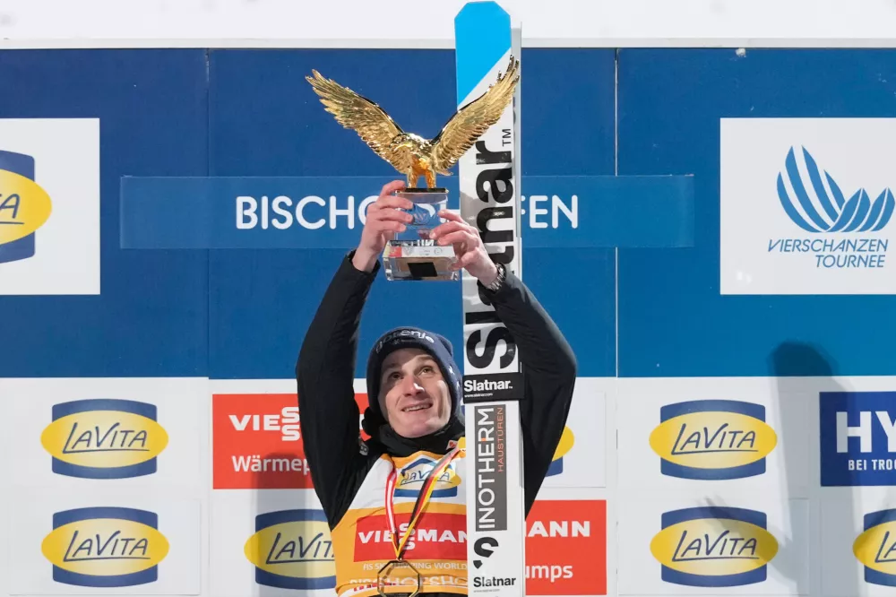 Domen Prevc, of Slovenia, celebrates on the podium after winning the Four Hills ski jumping tournament in Bischofshofen, Austria, Tuesday, Jan. 6, 2026. (AP Photo/Matthias Schrader)