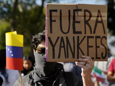 A man holds a placard reading "Yankees out", as protesters gather outside the U.S. embassy, after U.S. President Donald Trump said that the U.S. attacked Venezuela and deposed its President Nicolas Maduro, in Mexico City, Mexico January 3, 2026. REUTERS/Toya Sarno Jordan