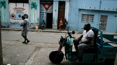 FILE PHOTO: Errilddy Almeida sits on his cargo motorbike during a blackout as top officials of the National Assembly announce that the Cuban economy is predicted to grow 1% in 2026, in Havana, Cuba December 18, 2025. REUTERS/Norlys Perez/File Photo