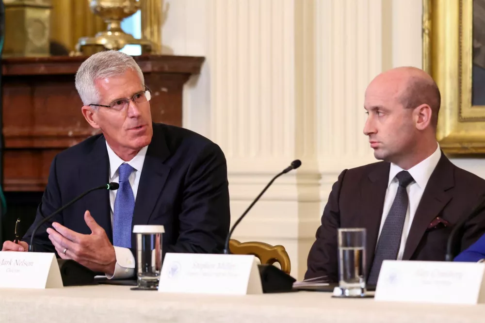 Chevron vice chair Mark A. Nelson speaks as U.S. President Donald Trump's senior aide Stephen Miller looks on, during a U.S. President Donald Trump's meeting with oil industry executives, at the White House in Washington, D.C., U.S., January 9, 2026. REUTERS/Kevin Lamarque