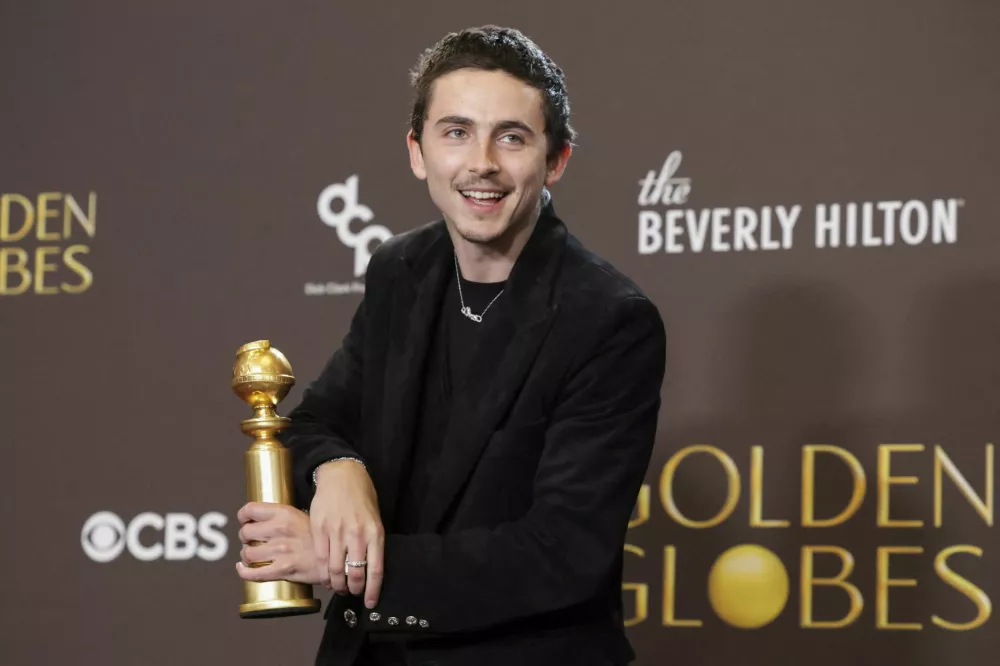Timothee Chalamet poses with the Best Performance by a Male Actor in a Motion Picture - Musical or Comedy award for "Marty Supreme" at the 83rd Annual Golden Globes in Beverly Hills, California, U.S., January 11, 2026. REUTERS/Mario Anzuoni