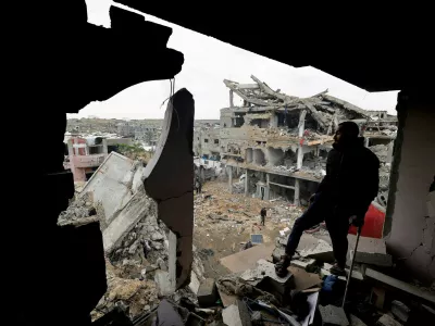 FILE PHOTO: Palestinians inspect the site of Thursday's Israeli strike on a house, in the central Gaza Strip, January 9, 2026. REUTERS/Mahmoud Issa/File Photo