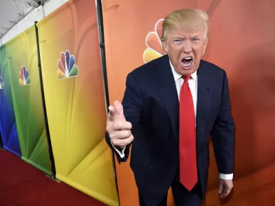 FILE - In this Jan. 16, 2015 file photo, Donald Trump, host of the television series "The Celebrity Apprentice," mugs for photographers at the NBC 2015 Winter TCA Press Tour in Pasadena, Calif. NBC on Monday, June 29, 2015 said that it is ending its business relationship with Trump, now a Republican presidential candidate, because of comments he made about immigrants during the announcement of his campaign. (Photo by Chris Pizzello/Invision/AP, File)