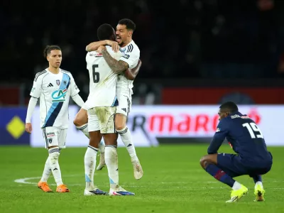 Soccer Football - Coupe de France - Round of 32 - Paris St Germain v Paris FC - Parc des Princes, Paris, France - January 12, 2026 Paris FC's Otavio and Timothee Kolodziejczak celebrate after the match as Paris St Germain's Ousmane Dembele looks dejected REUTERS/Gonzalo Fuentes   TPX IMAGES OF THE DAY