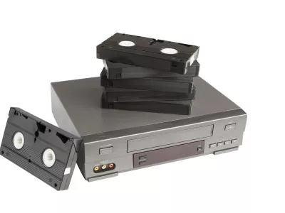 stack of videotapes on videorecorder isolated on white background