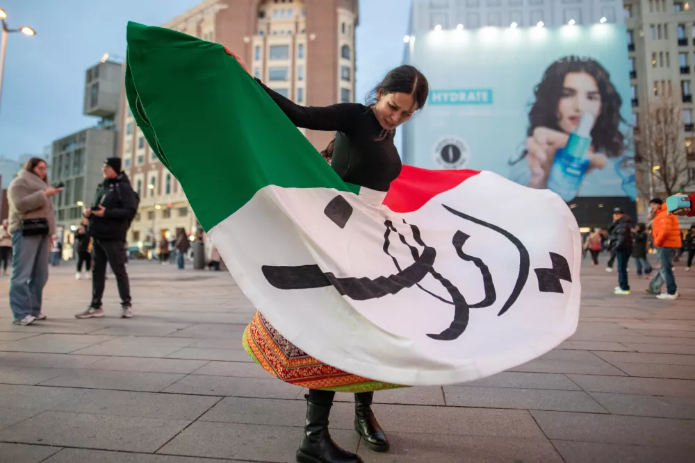 12 January 2026, Spain, Madrid: A young woman of Iranian origin dances the traditional 'Simurgh Dance' in Madrid's Plaza de Callao. Photo: David Canales/SOPA Images via ZUMA Press Wire/dpa