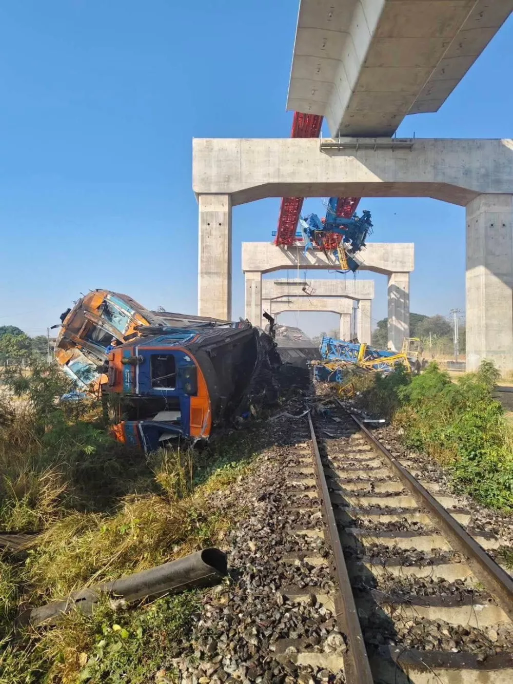 A train traveling from Bangkok to Ubon Ratchathani lies damaged after being derailed when a construction crane fell onto one of its carriages, causing multiple casualties, in Sikhio district, Nakhon Ratchasima province, Thailand, January 14, 2026. Ministry of Transport/Handout via REUTERS. THIS IMAGE HAS BEEN SUPPLIED BY A THIRD PARTY. NO RESALES. NO ARCHIVES.   TPX IMAGES OF THE DAY
