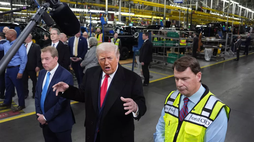 President Donald Trump speaks as Bill Ford, Executive Chairman of Ford, left, and Jim Farley, CEO of Ford, listen during a tour of the Ford River Rogue complex, Tuesday, Jan. 13, 2026, in Dearborn, Mich. (AP Photo/Evan Vucci)