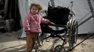 13 January 2026, Palestinian Territories, Nusairat: A Palestinian child stands outside their tent in the western part of Nuseirat Refugee Camp in central of Gaza Strip. Storms and heavy rainfall affecting the Gaza Strip have severely impacted the lives of Palestinians living in makeshift tents. Photo: Moiz Salhi/APA Images via ZUMA Press Wire/dpa
