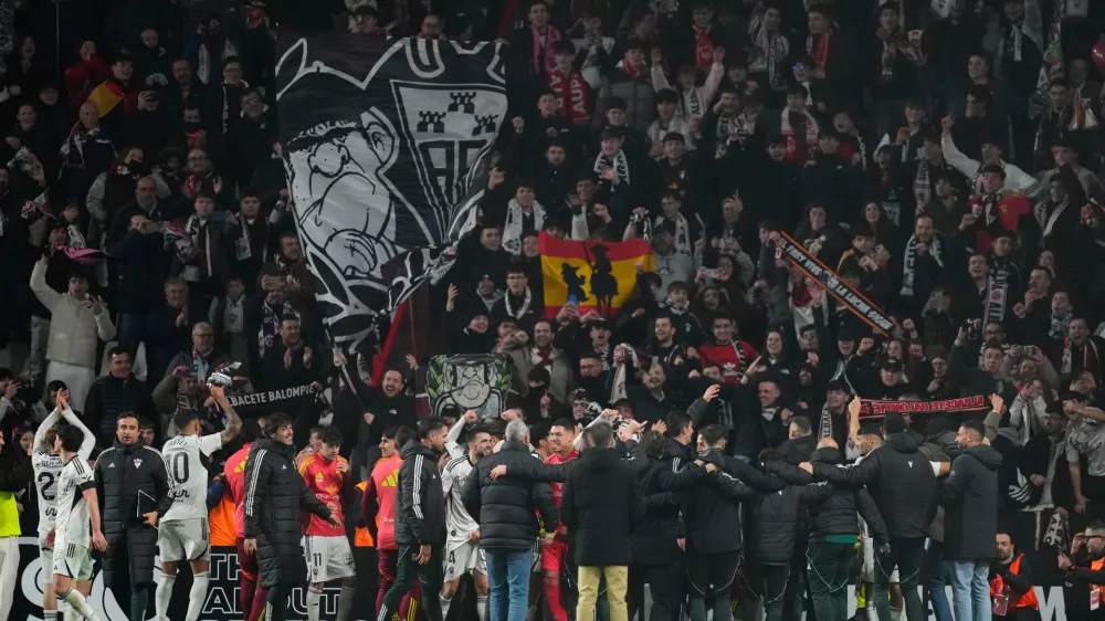 Albacete's players celebrate their team victory at the end the Copa del Rey round of 16 soccer match between Albacete and Real Madrid, in Albacete, Spain, Wednesday, Jan. 14, 2026. (AP Photo/Jose Breton)