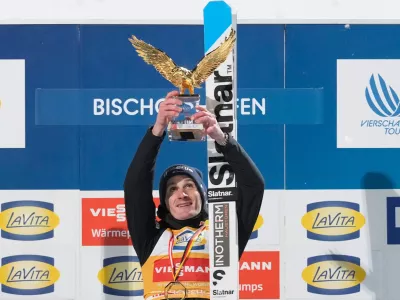 Domen Prevc, of Slovenia, celebrates on the podium after winning the Four Hills ski jumping tournament in Bischofshofen, Austria, Tuesday, Jan. 6, 2026. (AP Photo/Matthias Schrader)