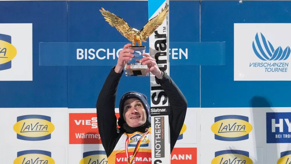 Domen Prevc, of Slovenia, celebrates on the podium after winning the Four Hills ski jumping tournament in Bischofshofen, Austria, Tuesday, Jan. 6, 2026. (AP Photo/Matthias Schrader)