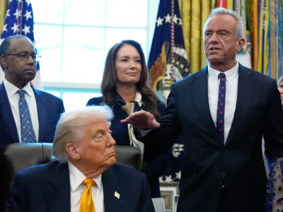 President Donald Trump, Dr. Ben Carson, Agriculture Secretary Brooke Rollins listen as Health and Human Services Secretary Robert F. Kennedy Jr. speaks in the Oval Office of the White House, Wednesday, Jan. 14, 2026, in Washington. (AP Photo/Alex Brandon)