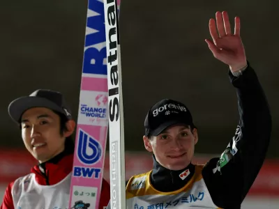 Ski Jumping - Ski Jumping World Cup - Sapporo, Japan - January 17, 2026 Slovenia's Domen Prevc celebrates after winning the men's large hill along with second placed Japan's Naoki Nakamura REUTERS/Issei Kato