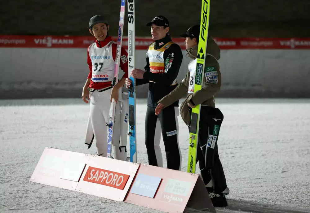 Ski Jumping - Ski Jumping World Cup - Sapporo, Japan - January 17, 2026 Slovenia's Domen Prevc celebrates after winning the men's large hill along with second placed Japan's Naoki Nakamura and Japan's Ren Nikaido REUTERS/Issei Kato