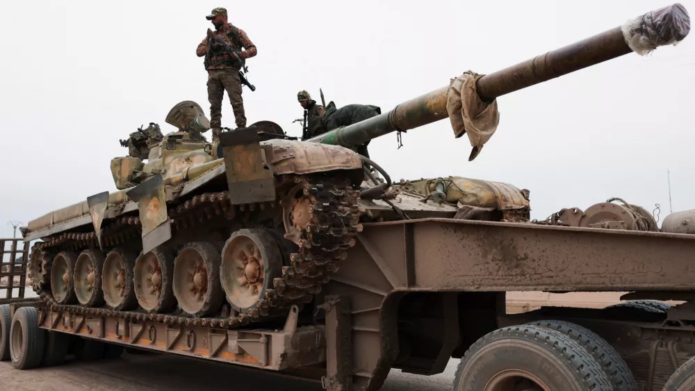 A member of the Syrian army stands over a tank, following the withdrawal of Kurdish-led Syrian Democratic Forces (SDF), in Maskanah, near Aleppo, Syria, January 17, 2026. REUTERS/Mahmoud Hassano