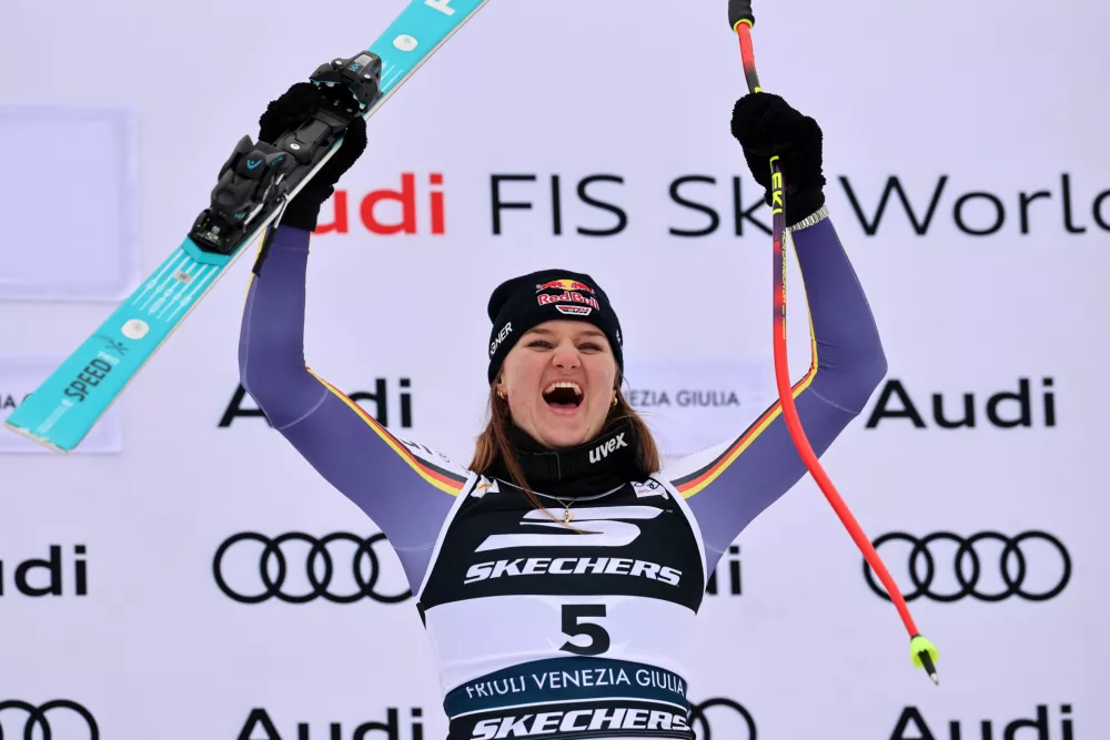 Germany's Emma Aicher celebrates on the podium after winning an alpine ski, women's World Cup Super G, in Tarvisio, Italy, Sunday, Jan. 18, 2026. (AP Photo/Marco Trovati)