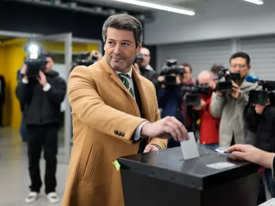 Presidential candidate Andre Ventura, of the populist Chega party, poses for the cameras when casting his ballot in Portugal's presidential election at a polling station in Lisbon, Sunday, Jan. 18, 2026. (AP Photo/Armando Franca)