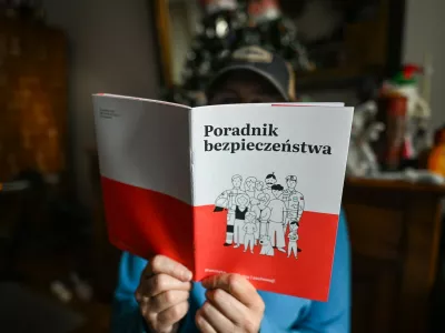 KRAKOW, POLAND - JANUARY 18:A person reads a copy of the Security Guide (Polish: Poradnik Bezpieczenstwa), distributed to households nationwide by the Polish government, in Krakow, Poland, on January 18, 2026.The guide aims to help residents prepare for crisis situations such as natural disasters, infrastructure failures, cyber threats and potential military scenarios, with 16.8 million copies scheduled for delivery by the end of January.Security Guide Delivered To Households Across Poland, Krakow - 18 Jan 2026,Image: 1067214354, License: Rights-managed, Restrictions:, Model Release: no