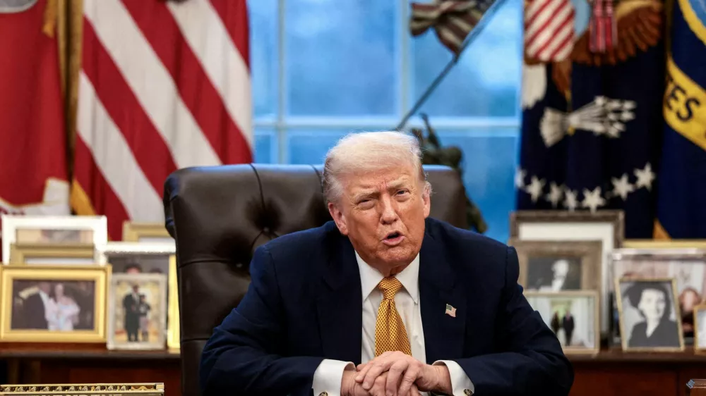 FILE PHOTO: U.S. President Donald Trump is interviewed by Reuters White House correspondent Steve Holland (not pictured) during an exclusive interview in the Oval Office in the White House in Washington, D.C., U.S., January 14, 2026. REUTERS/Evelyn Hockstein/File Photo