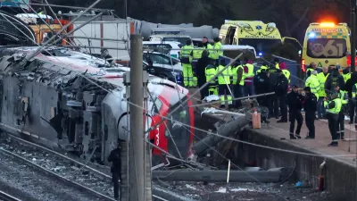 Members of the Spanish Civil Guard, along with other emergency personnel, work next to one of the trains involved in the accident, at the site of a deadly derailment of two high-speed trains near Adamuz, in Cordoba, Spain, January 19, 2026. REUTERS/Susana Vera