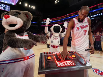 Houston Rockets forward Kevin Durant (7) presses a launch button after surpassing Dirk Nowitzki to become the NBA's sixth all-time leading scorer in an NBA basketball game against the New Orleans Pelicans in Houston, Sunday, Jan. 18, 2026. (AP Photo/Ashley Landis)