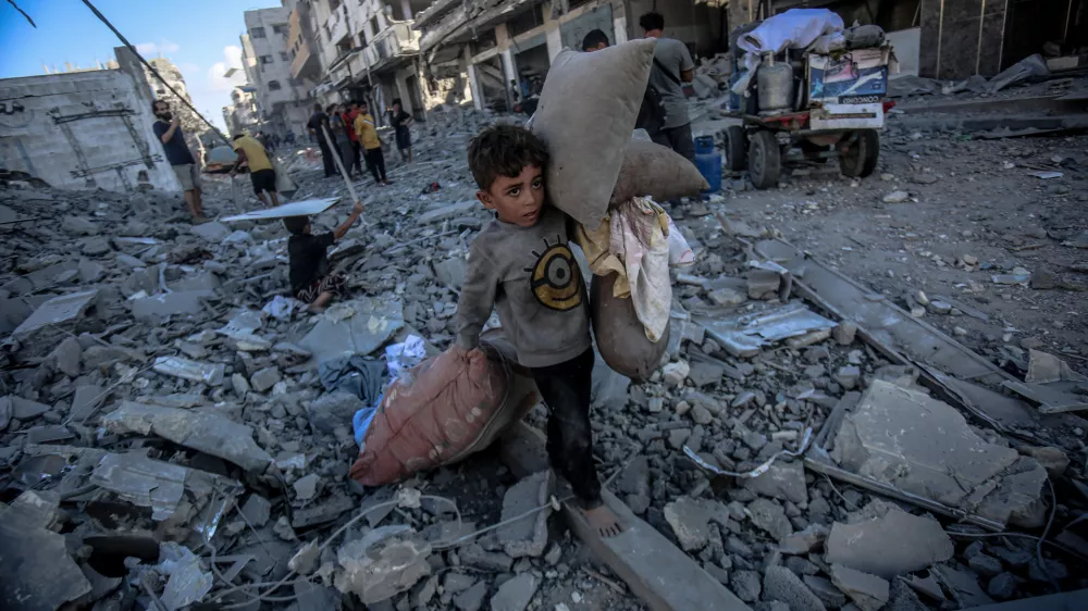 GAZA CITY, GAZA - SEPTEMBER 30: Palestinian children collect usable belongings from the rubble after the Israeli strike on Abu Hasira Street in Gaza City, Gaza, on September 30, 2025. Several buildings were completely destroyed, and many others were severely damaged in the strike. Saeed M. M. T. Jaras / AnadoluNo Use USA No use UK No use Canada No use France No use Japan No use Italy No use Australia No use Spain No use Belgium No use Korea No use South Africa No use Hong Kong No use New Zealand No use Turkey