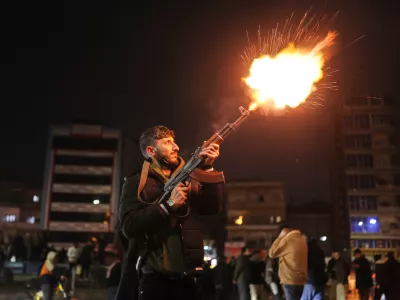 A member of the government forces fires into the air in celebration after taking control of the town from the Syrian Democratic Forces (SDF) in Raqqa, northeastern Syria, Sunday, Jan. 18, 2026. (AP Photo/Ghaith Alsayed)