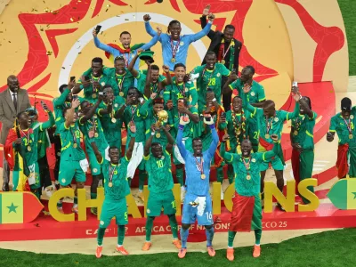 Senegal's Sadio Mane holds the trophy aloft as he celebrates with teammates after winning the Africa Cup of Nations final soccer match between Senegal and Morocco in Rabat, Morocco, Sunday, Jan. 18, 2026. (AP Photo/Youssef Loulidi)