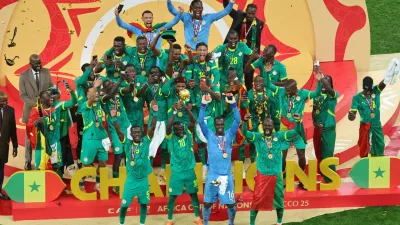 Senegal's Sadio Mane holds the trophy aloft as he celebrates with teammates after winning the Africa Cup of Nations final soccer match between Senegal and Morocco in Rabat, Morocco, Sunday, Jan. 18, 2026. (AP Photo/Youssef Loulidi)