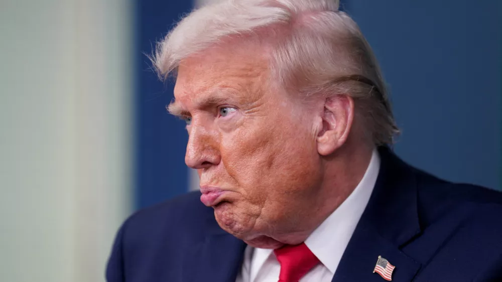 U.S. President Donald Trump reacts during a press briefing at the White House, on the one-year mark into his second term in office, in Washington, D.C., U.S., January 20, 2026. REUTERS/Nathan Howard