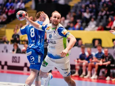 Slovenia's Domen Tajnik in action during the European Championship handball match between Slovenia and the Faroe Islands in Baerum, Norway Tuesday Jan. 20, 2026. (Erik Flaaris Johansen/NTB via AP)