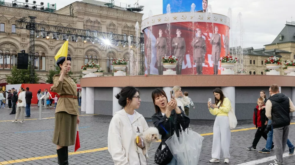 Chinese tourists take a selfie at Red Square during an installation dedicated to the 80th anniversary of the Victory Parade, in Moscow. June 22, 2025. China has become trendy for Russians who once worshiped everything Western.,Image: 1016509926, License: Rights-managed, Restrictions:, Model Release: no