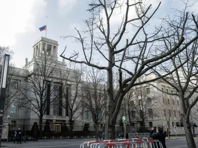 FILE -A man takes a photo of the Russian embassy in Berlin, Germany, Tuesday, March 27, 2018. (AP Photo/Markus Schreiber, File)