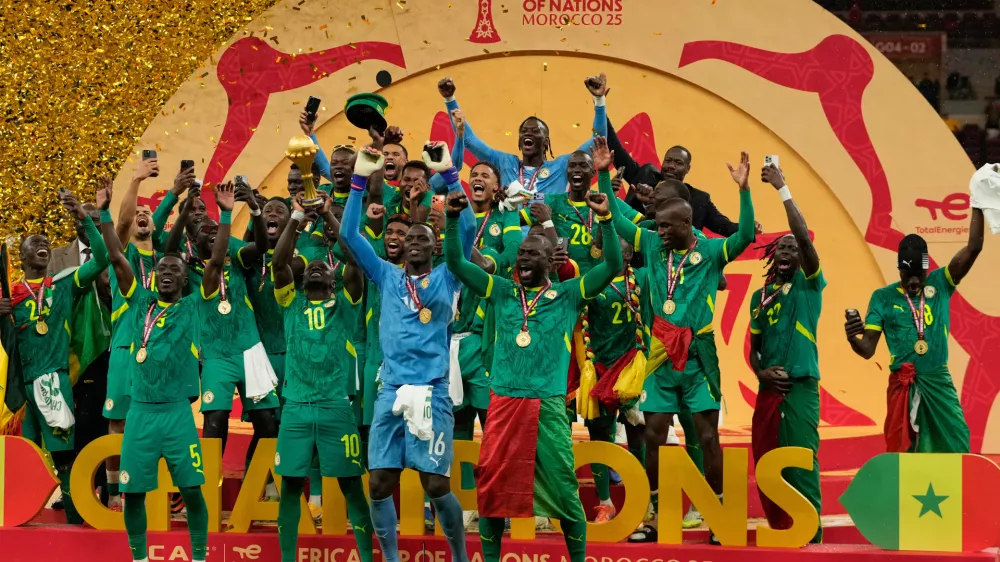 Senegalese players celebrate after winning the Africa Cup of Nations final soccer match agaisnt Morocco, in Rabat, Morocco, Sunday, Jan. 18, 2026. (AP Photo/Mosa'ab Elshamy)