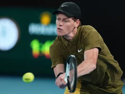 Jannik Sinner of Italy plays a backhand return to James Duckworth of Australia during their second round match at the Australian Open tennis championship in Melbourne, Australia, Thursday, Jan. 22, 2026. (AP Photo/Aaron Favila)