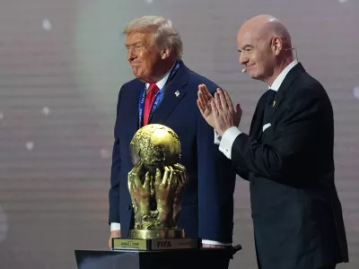 President Donald Trump receives the FIFA Peace Prize from FIFA President Gianni Infantino during the draw for the 2026 soccer World Cup at the Kennedy Center in Washington, Friday, Dec. 5, 2025. (AP Photo/Jacquelyn Martin)
