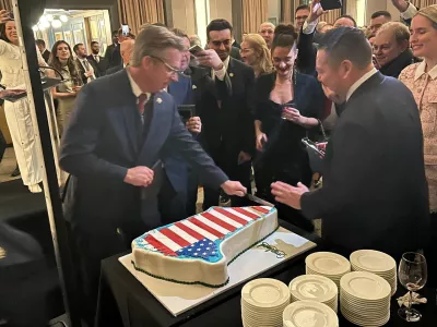 A Greenland-shaped cake decorated with the U.S. flag is being sliced at the Republicans for National Renewal anniversary event at the Kennedy Center in Washington, D.C., U.S., January 20, 2026. Republicans for National Renewal/via REUTERS THIS IMAGE HAS BEEN SUPPLIED BY A THIRD PARTY. MANDATORY CREDIT. NO RESALES. NO ARCHIVES. MANDATORY CREDIT. Verification line: Reuters was able to verify the location with the floor tiles, the windows and interior design that matched the file imagery from the interior of the Kennedy Center. The date was confirmed by the Republicans for National Renewal and verified by the corroborating visuals from the event.