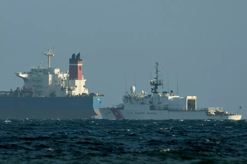 A U.S. Coast Guard vessel guards the oil tanker Galileo, previously known as the Veronica, after it was seized by the United States, as it is moored off the coast of Ponce, Puerto Rico, January 21, 2026. REUTERS/Ricardo Arduengo