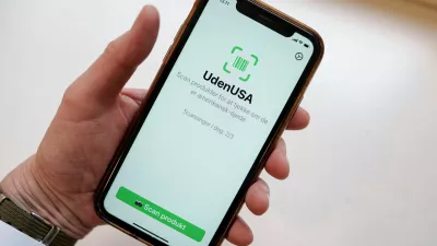 Close up on a cell phone with the app called "UdenUSA", which translates to withoutUSA in Danish and can filter out American products in supermarkets, in Copenhagen, Wednesday Jan. 21, 2026. (Liselotte Sabroe/Ritzau Scanpix via AP)