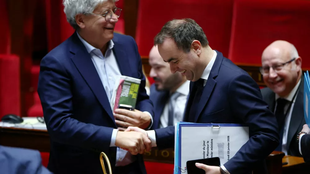 French Prime Minister Sebastien Lecornu shakes hands with Member of parliament Eric Coquerel, of La France Insoumise (LFI) and the "Nouveau Front Populaire" (New Popular Front - NFP) parliamentary group and President of the National Assembly's finance commission, after the announcement of the use by the French government of article 49.3, a special clause in the French Constitution, to push the second part of the budget bill for 2026 (PLF 2026) through the National Assembly without a vote by lawmakers, during a new debate on the draft budget bill at the National Assembly in Paris, France, January 23, 2026. REUTERS/Gonzalo Fuentes