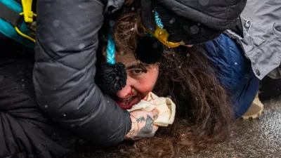 Federal agents detain a person on Wednesday, Jan. 21, 2026, in Minneapolis. (AP Photo/Angelina Katsanis)